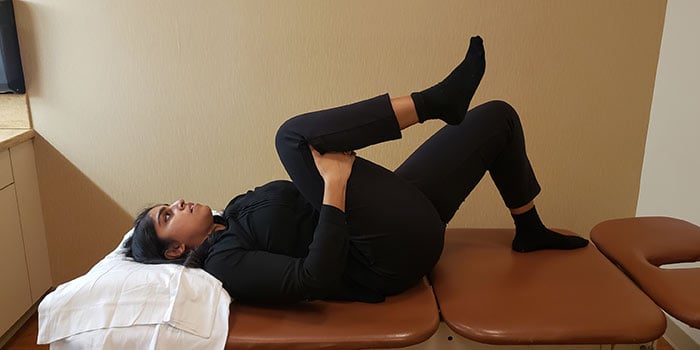 lying single knee to chest